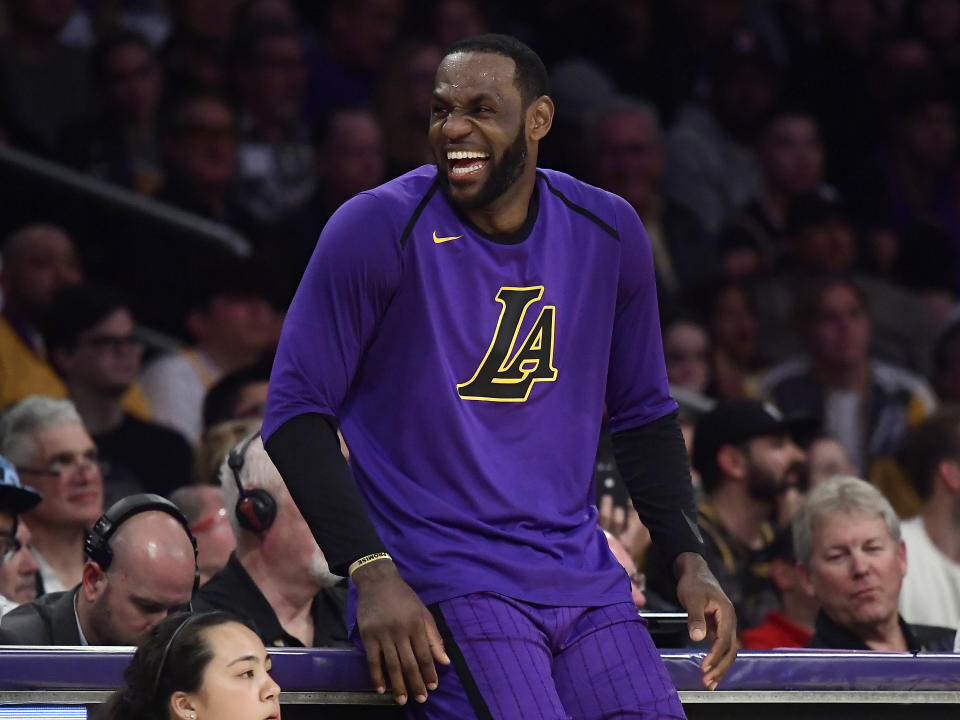 Los Angeles Lakers forward LeBron James laughs as he waits to check in to the team's NBA basketball game against the Charlotte Hornets during the second half Friday, March 29, 2019, in Los Angeles. The Lakers won 129-115. (AP Photo/Mark J. Terrill)