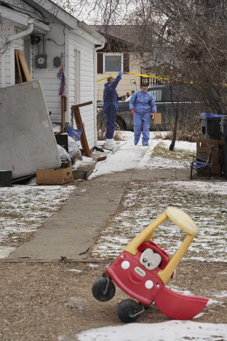 Forensic investigators work at the scene of an ongoing investigation regarding five deaths in southern Manitoba, in Carman, Manitoba, Monday, Feb. 12, 2024. A Canadian man has been charged with five counts of first-degree murder in the deaths of his wife, three young children and a 17-year-old female relative, authorities said Monday. (David Lipnowski/The Canadian Press via AP)