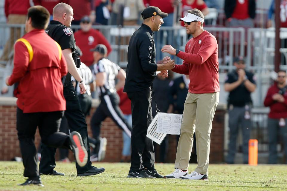 Iowa State coach Matt Campbell shakes hands with Oklahoma coach Lincoln Riley after the Sooners beat the Cyclones, 28-21, on Saturday.