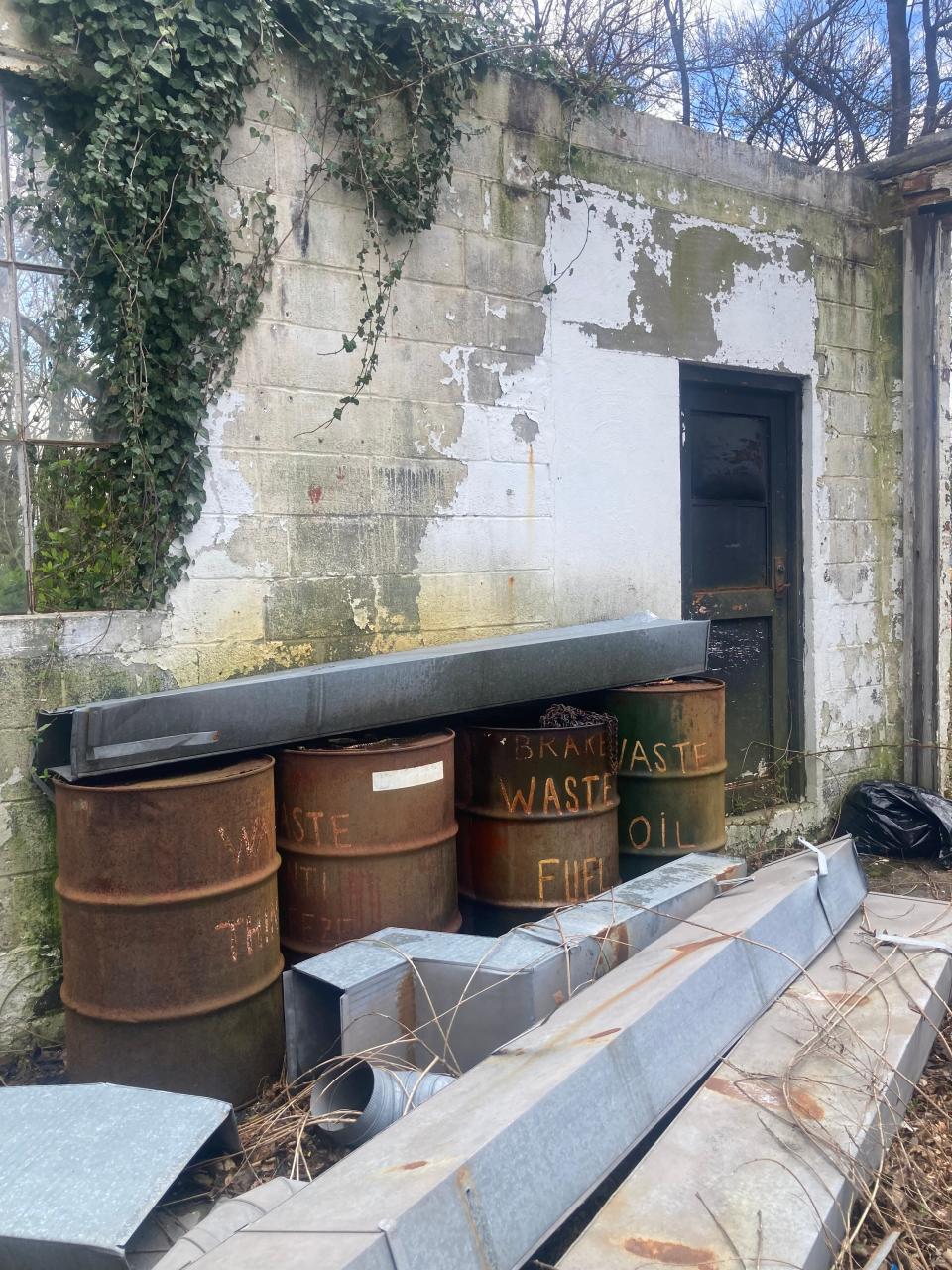 Metal barrels marked "Waste Fuel" and "Waste Oil" at 654 Lincoln Highway in Falls. The township zoning hearing board will consider granting variances to a developer who wants to build age-restricted condos/apartments on the site of the old Lincoln Garage.