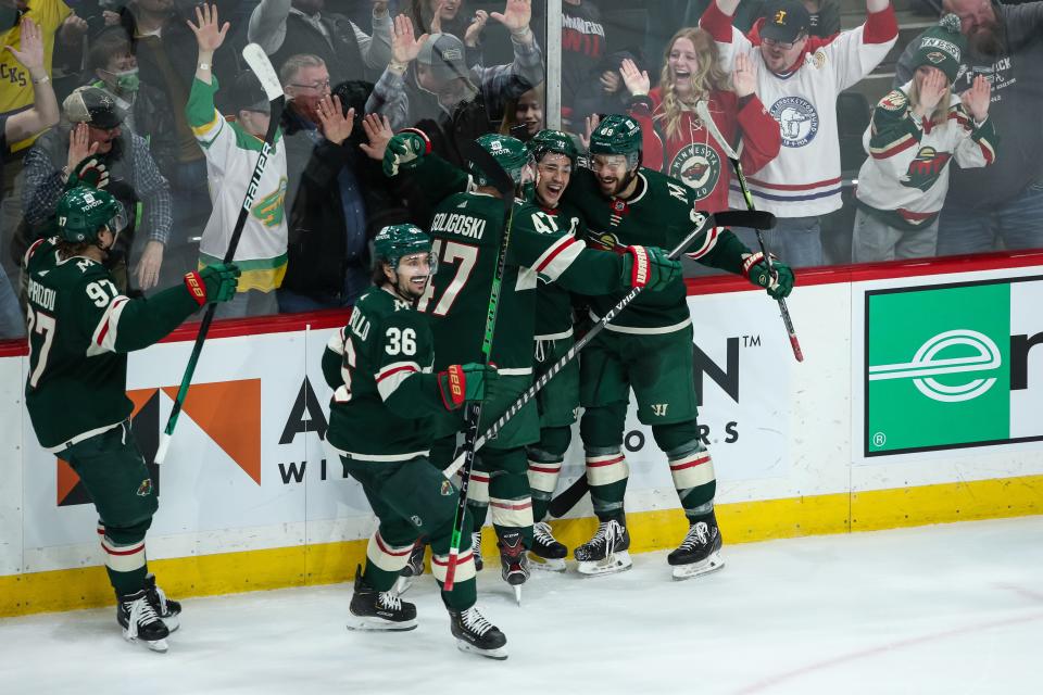 Mar 26, 2022; Saint Paul, Minnesota, USA; Minnesota Wild defenseman Jared Spurgeon (46) celebrates with teammates after defeating the Columbus Blue Jackets at Xcel Energy Center. Mandatory Credit: David Berding-USA TODAY Sports