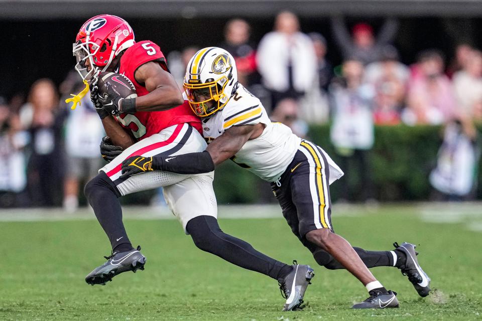 Georgia Bulldogs wide receiver Rara Thomas is tackled by Missouri Tigers defensive back Ennis Rakestraw Jr. during the second half at Sanford Stadium, Nov. 4, 2023.