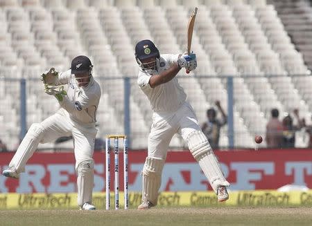 Cricket - India v New Zealand - Second Test cricket match - Eden Gardens, Kolkata - 30/09/2016. India's Cheteshwar Pujara (R) plays a shot past New Zealand's wicketkeeper Bradley-John Watling. REUTERS/Rupak De Chowdhuri