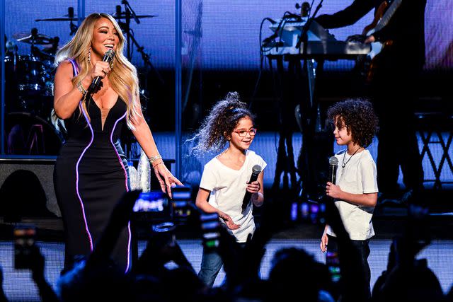 <p>Kevin Mazur/Getty</p> Mariah Carey and the twins hit the stage in 2019