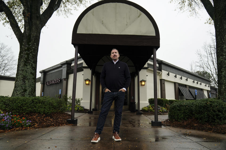 Josh Kern, the CEO of SPG Hospitality, poses at a J. Alexander's, one of the restaurants operated by the company, on Wednesday, Dec. 14, 2022, in Atlanta. Restaurants and grocery stores are struggling to contain higher costs and figure out whether they can pass them along to customers as higher prices. (AP Photo/John Bazemore )