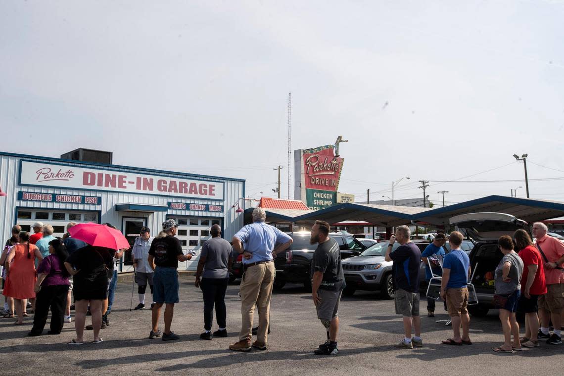 Patrons line up around the corner to buy fixtures, menus and merchandise from Parkette Drive-In during a sale in Lexington, Ky., Saturday, July 23, 2022.