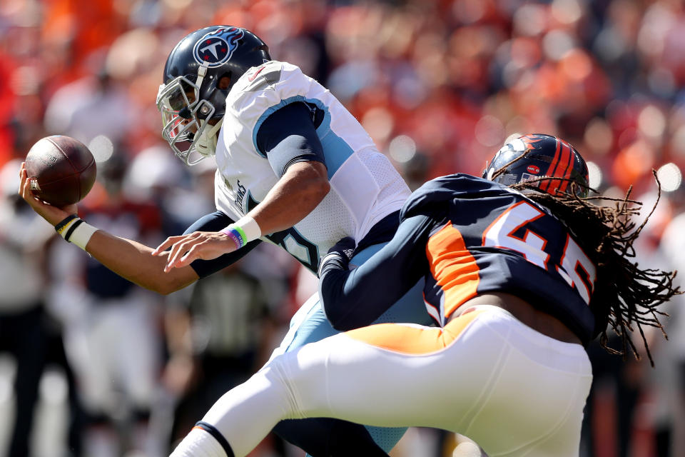 Quarterback Marcus Mariota of the Tennessee Titans is sacked by Alexander Johnson of the Denver Broncos. (Getty Images)