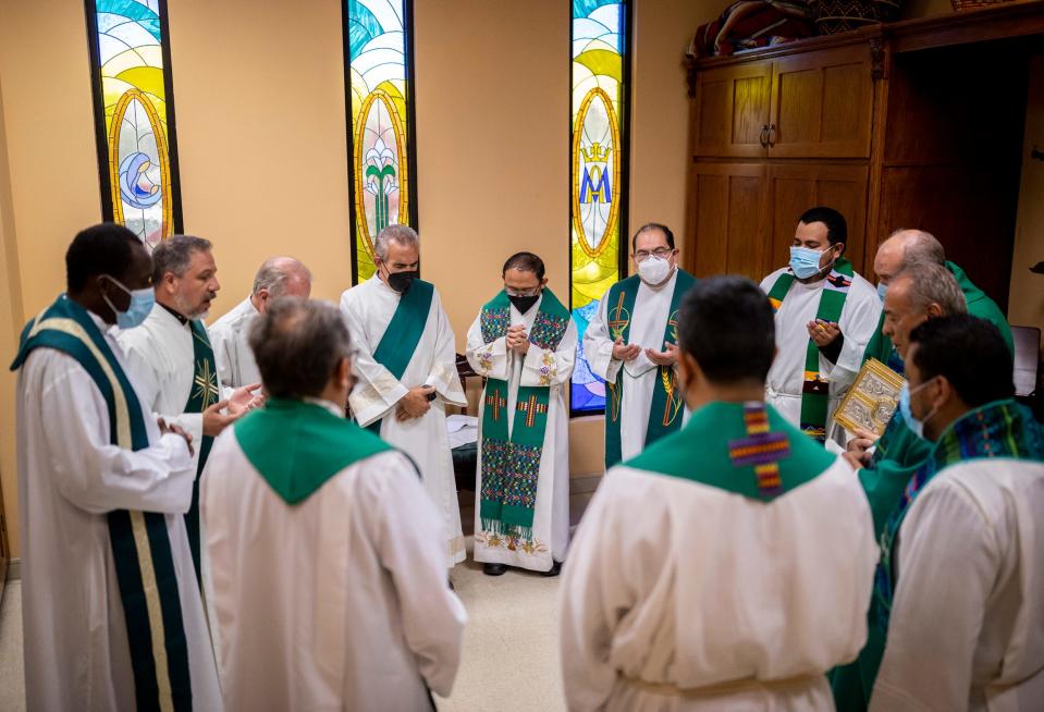 Local clergy pray in a circle before the last Mass of Monsignor Arturo J. Bañuelas, who is retiring in July after 46 years of service in the Diocese of El Paso.