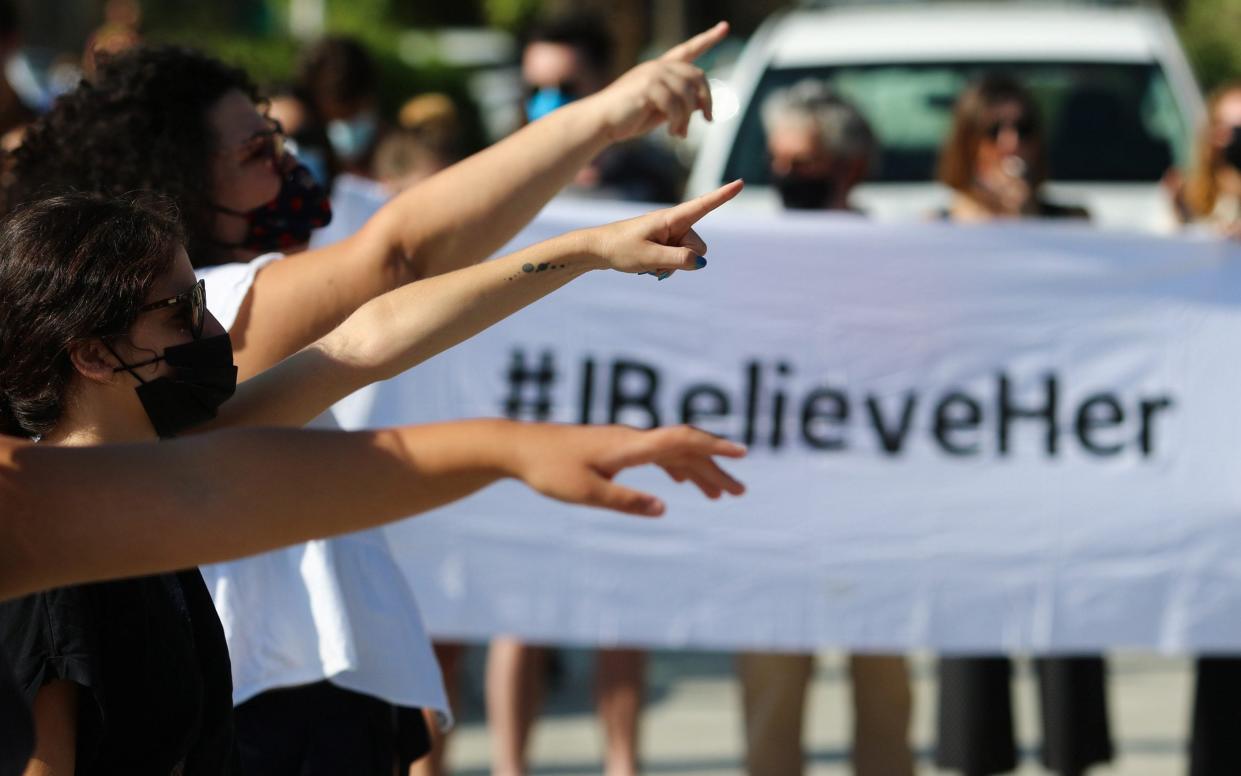 Activists take part in a demonstration supporting a British woman who says she was pressured into retracting a claim of gang rape, outside the Supreme Court in Nicosia - Reuters