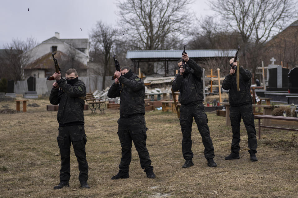 Salutes are fired during the funeral of senior police sergeant Roman Rushchyshyn in the village of Soposhyn, outskirts of Lviv, western Ukraine, Thursday, March 10, 2022, in Lviv. Rushchyshyn, a member of the Lviv Special Police Patrol Battalion, was killed in the Luhansk Region. (AP Photo/Bernat Armangue)