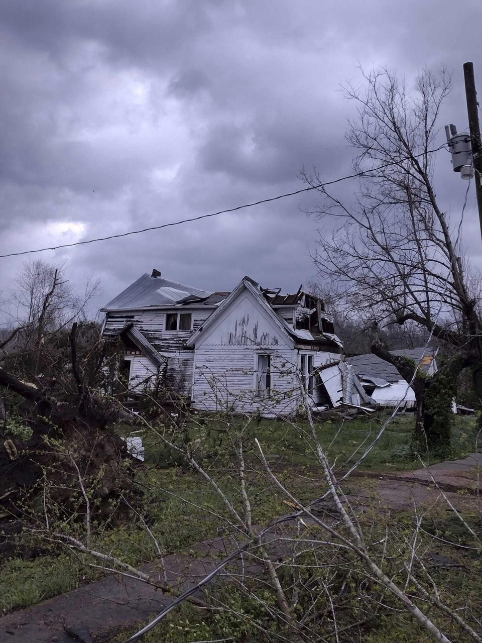 Debris covers the ground as homes are damaged after severe weather in Glen Allen, Mo., on Wednesday, April 5, 2023. A large tornado tore through southeastern Missouri before dawn on Wednesday, killing several people and causing widespread destruction. (Courtesy of Josh Wells via AP)