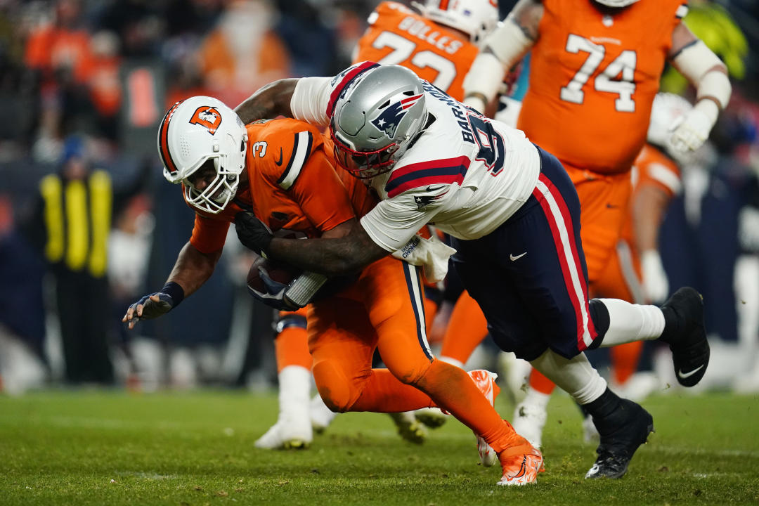 Denver Broncos quarterback Russell Wilson is sacked by New England Patriots defensive tackle Christian Barmore (90) during the second half of an NFL football game against the New England Patriots, Sunday, Dec. 24, 2023, in Denver. (AP Photo/Geneva Heffernan)