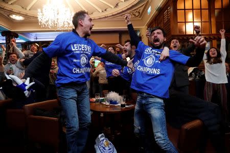 Britain Football Soccer - Leicester City fans watch the Chelsea v Tottenham Hotspur game in pub in Leicester - 2/5/16. Leicester City fans celebrate Chelsea's second goal. Reuters / Eddie Keogh