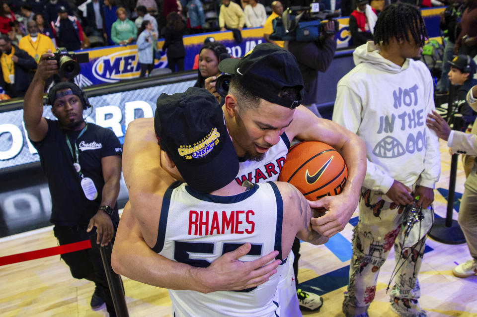 Howard's Jelani Williams (5) embraces teammate Freedom Rhames (55) after defeating Norfolk State in an NCAA college basketball game in the championship of the Mid-Eastern Athletic Conference Tournament, Saturday, March 11, 2023, in Norfolk, Va. (AP Photo/Mike Caudill)