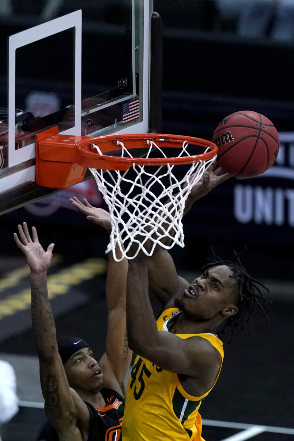 Baylor's Davion Mitchell (45) shoots over Oklahoma State's Avery Anderson III during the first half of an NCAA college basketball game in the semifinals of the Big 12 tournament in Kansas City, Mo., Friday, March 12, 2021. (AP Photo/Charlie Riedel)