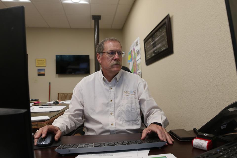 Kenneth Winkles, executive director at the Pecos Economic Development Corporation works at his desk, May 31, 2023 in Pecos, Texas.