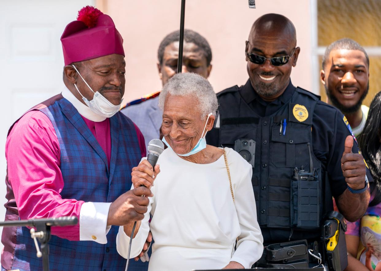 Bishop Thomas Masters, left, and police Sgt. Roosevelt Lee  help Thelma Wright Edwards, the oldest living close relative of Emmett Till after she spoke at New Macedonia Missionary Baptist Church in Riviera Beach, Florida on June 19, 2022.