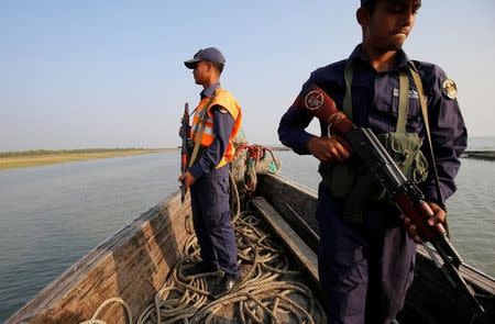 Bangladesh coast guards patrol in a vessel, near the Thengar Charan island in the Bay of Bengal, Bangladesh, February 2, 2017. Picture taken February 2, 2017. REUTERS/Mohammad Ponir Hossain