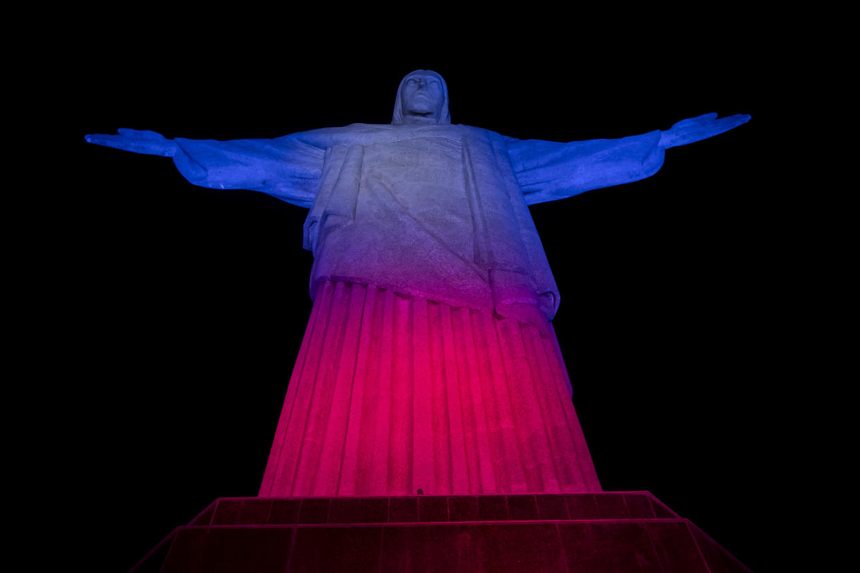 The Christ the Redeemer statue is illuminated in red, blue and white, the colors of the flag of The United Kingdom, as a tribute to Queen Elizabeth II on her passing, in Rio de Janeiro, Brazil, Thursday, Sept. 8, 2022. (AP Photo/Bruna Prado)