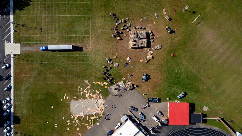 A semitrailer gets ready to offload shipping pallets and other wood to be used for the bonfire Thursday night at Crater Stadium as part of the annual Dover-Phila Week football rivalry celebration The wood was donated by Deflecto in Dover. Other companies in the area also donated materials.