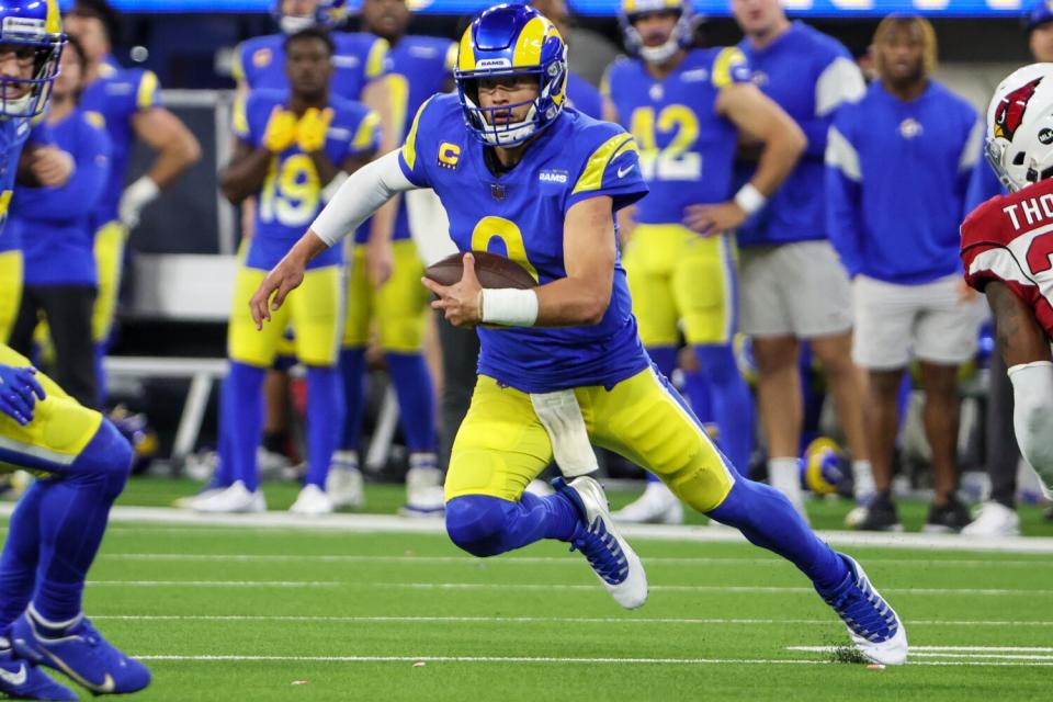 Rams quarterback Matthew Stafford scrambles during a drive against the Arizona Cardinals in the playoffs.