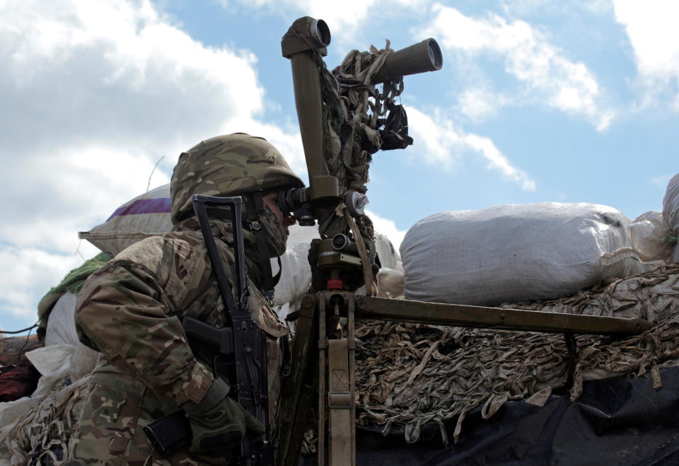  A service member of the Ukrainian armed forces uses periscopes while observing the area at fighting positions on the line of separation near the rebel-controlled city of Donetsk, Ukraine.