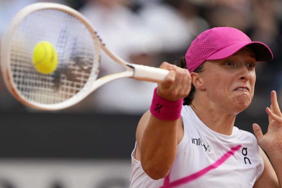 Iga Swiatek, of Poland, returns the ball to Aryna Sabalenka, of Belarus, during the Italian Open tennis tournament final match at Rome's Foro Italico, Saturday, May 18, 2024. (AP Photo/Alessandra Tarantino)