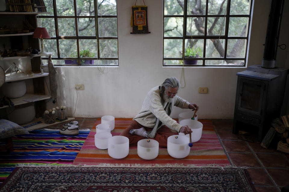 Daniel Brower plays crystal bowls at his home in Capilla del Monte, Cordoba, Argentina, Tuesday, July 18, 2023. Brower renounced his Christian upbringing and now looks for his spirituality through music and nature. In the pope’s homeland of Argentina, Catholics have been renouncing the faith and joining the growing ranks of the religiously unaffiliated. Commonly known as the “nones,” they describe themselves as atheists, agnostics, spiritual but not religious, or simply: “nothing in particular.” (AP Photo/Natacha Pisarenko)