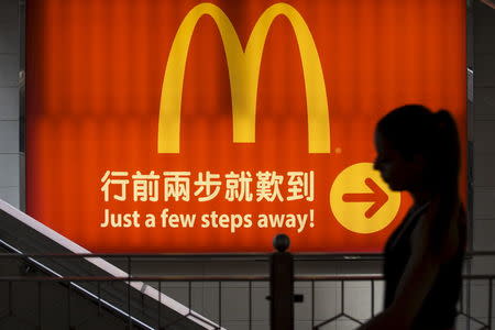 A woman walks past a McDonald's outlet in Hong Kong in this July 25, 2014 file photo. REUTERS/Tyrone Siu/Files