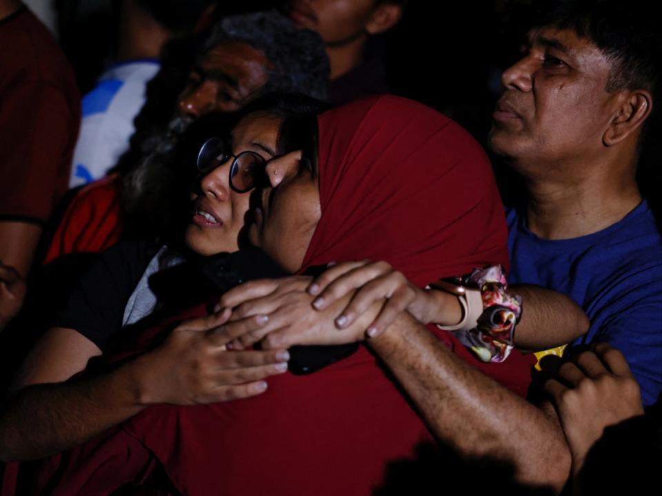 Onlookers watch anxiously (REUTERS)