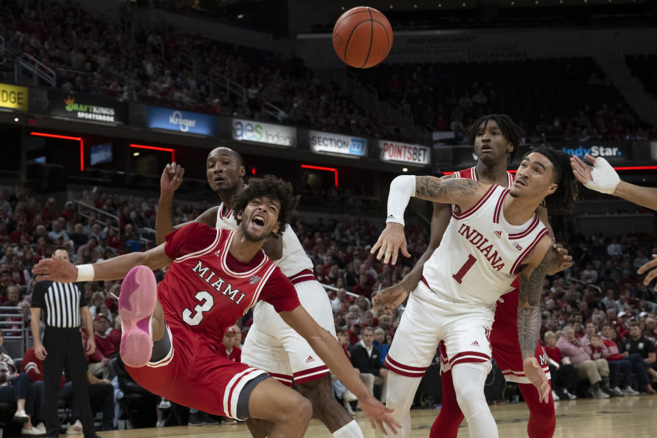 Miami (Ohio) guard Julian Lewis (3) and Indiana guard Jalen Hood-Schifino (1) react during the first half of an NCAA college basketball game, Sunday, Nov. 20, 2022, in Indianapolis. (AP Photo/Marc Lebryk)