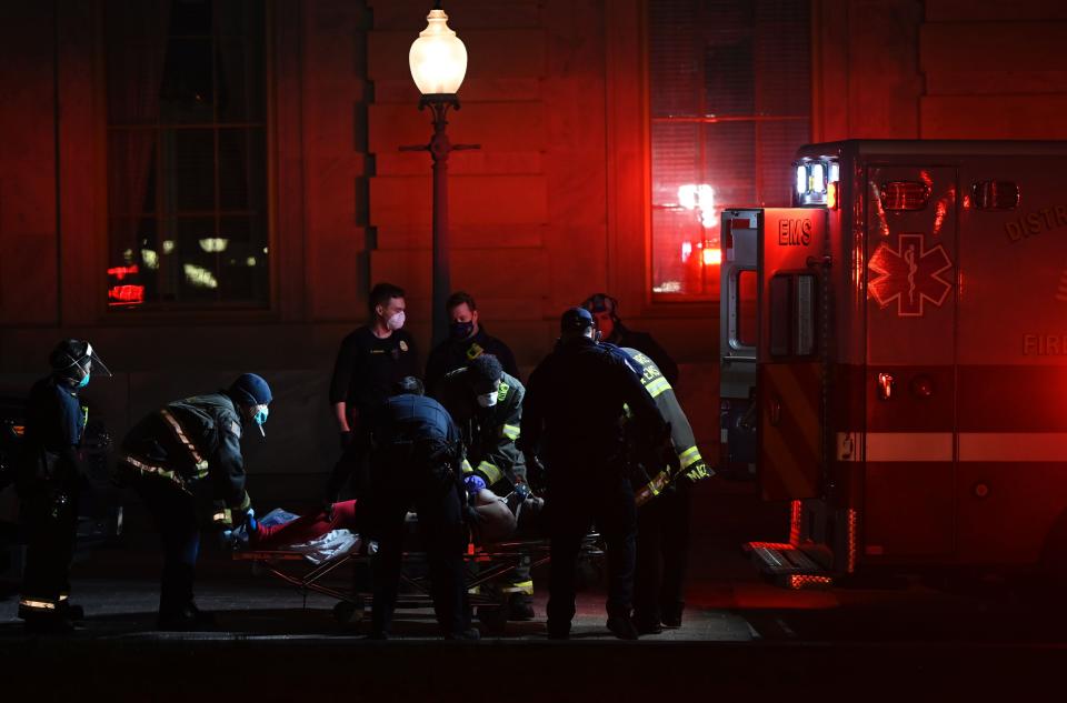 Paramedics perform cardiopulmonary resuscitation on a patient on January 6, 2021, in Washington, D.C. Demonstrators breeched security and entered the US Capitol in Washington, DC, as Congress debated the a 2020 presidential election Electoral Vote Certification. (Photo by ANDREW CABALLERO-REYNOLDS/AFP via Getty Images)