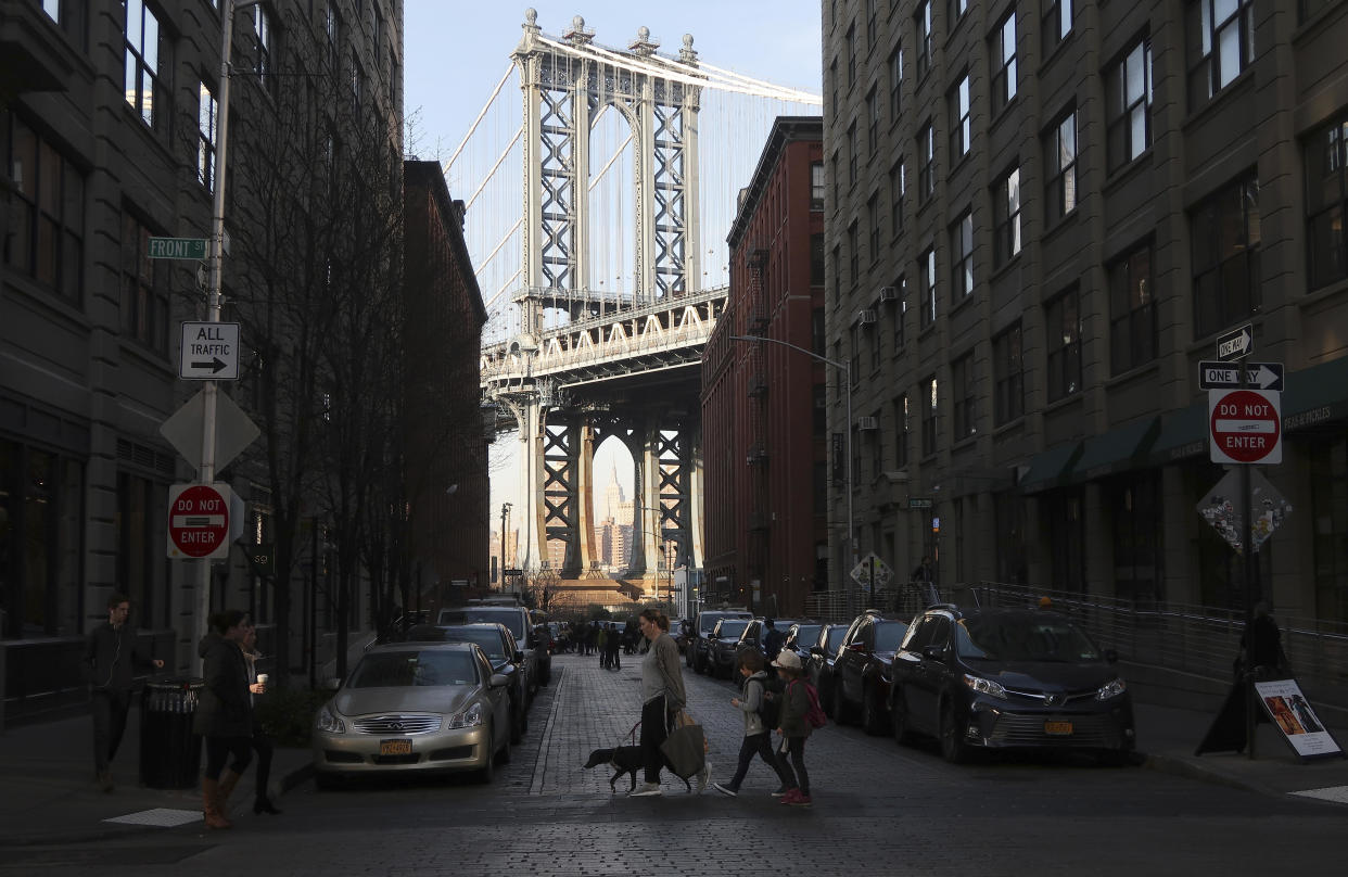 People cross Washington Street in front of the iconic Brooklyn view of the Manhattan Bridge and Empire State Building from the neighborhood of Dumbo on Feb. 5, 2019 in New York City. / Credit: Gary Hershorn / Getty Images