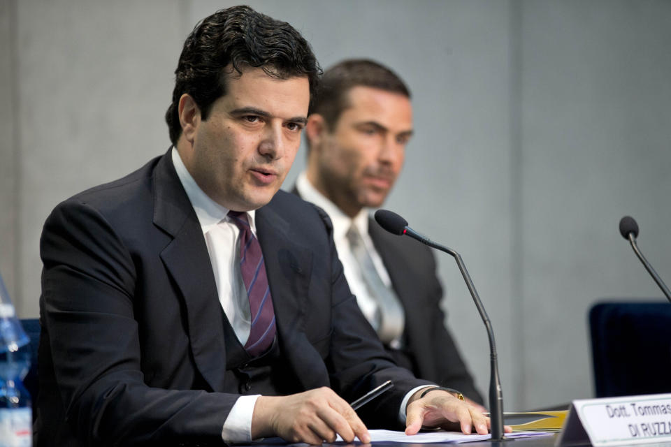 FILE -- In this April 28, 2016 file photo, Tommaso Di Ruzza, then director of the Vatican Financial Information Authority, left, flanked by Rene Brulhart, then president of the AIF. Di Ruzza is accused of abuse of office for allegedly failing to block the 15 million payment to broker Gianluigi Torzi or of alerting Vatican prosecutors to a seemingly suspect deal. (AP Photo/Andrew Medichini, file)