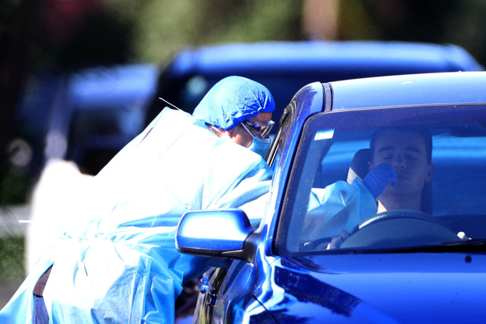 A nurse tests members of the public at the Eden Park testing station on Sunday. Source: Getty