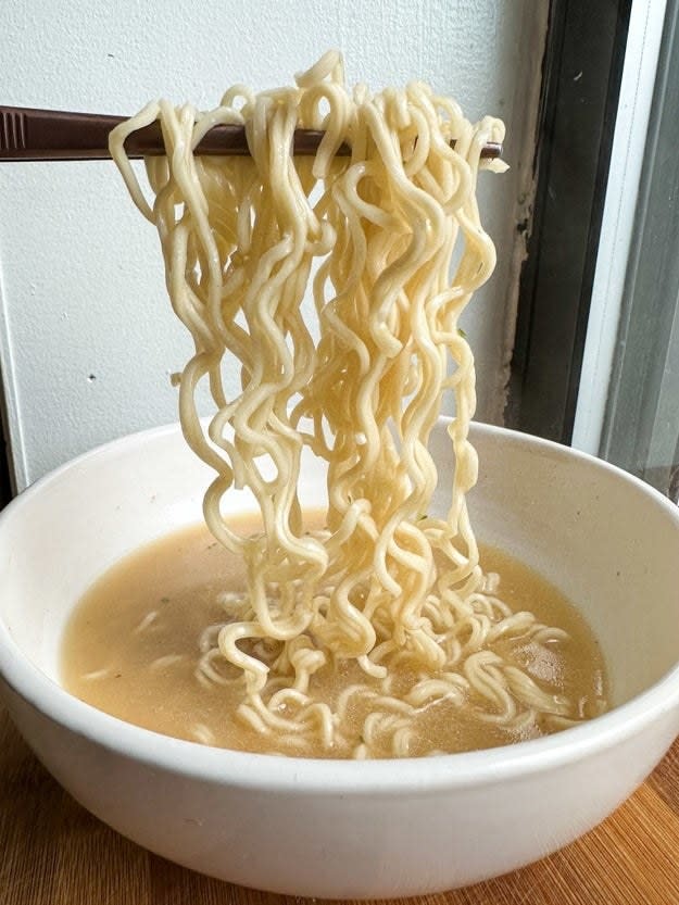holding up mike's ramen out of the bowl