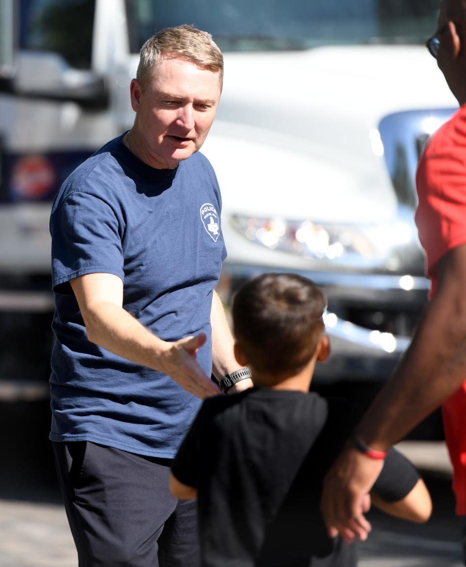 Canton Police Chief John Gabbard greets Jagger Bennett, 7, of Canton during this year's first We Believe in Canton free community event that was held Wednesday at Centennial Plaza in Canton.