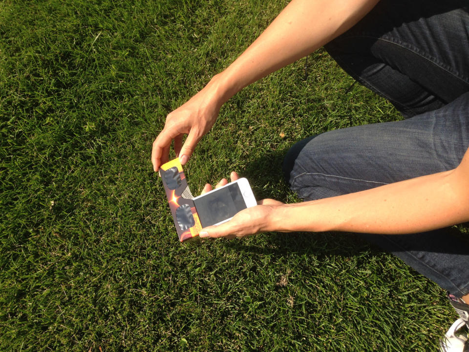 To protect your eyes and your device, photograph the sun using a solar filter, and use the front-facing camera so you can look down at the screen. <cite>Calla Cofield/Space.com</cite>