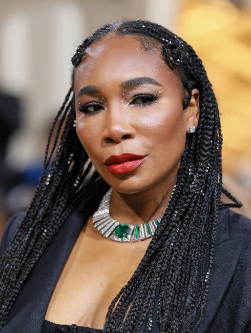 A closeup of Venus Williams that shows off her jeweled necklace, hair, and makeup