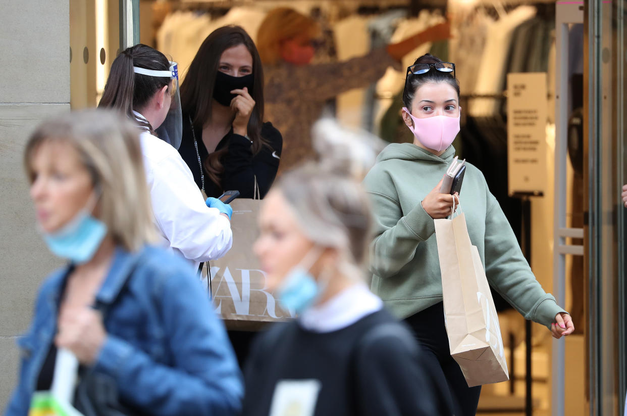 People wear a mask as they leave a shop in Buchanan Street in Glasgow as it became compulsory to wear face coverings in shops from today as Scotland continues with the gradual lifting of restrictions to ease out of lockdown.