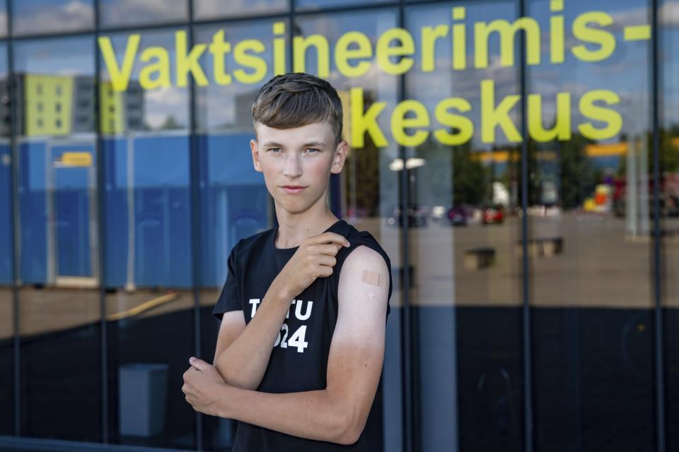 Joonas Leis , 12 years old boy, poses for a photo after getting a shot a coronavirus vaccine at a vaccination center inside a sports hall in Estonia's second largest city, Tartu, 164 km. south-east from Tallinn, Estonia, Thursday, July 29, 2021. Estonia's second largest city Tartu is making rapid progress in vaccinating children aged 12-17 ahead of the school year in September. Around half of the town's teenagers have already received their first vaccine, and local health officials are confident they will hit 70% in the coming 30 days. (AP Photo/Raul Mee)