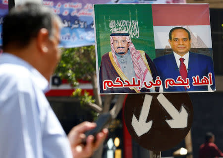 A man walks near a poster for Egypt's President Abdel Fattah al-Sisi (R) and Saudi Arabia's King Salman bin Abdulaziz al-Saud in Cairo, Egypt March 14, 2018. REUTERS/Amr Abdallah Dalsh