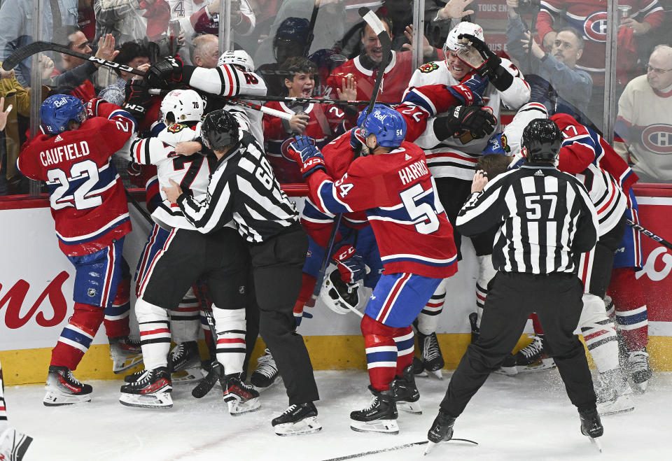 Players from the Montreal Canadiens and the Chicago Blackhawks brawl during the first period of an NHL hockey game in Montreal, Saturday, Oct. 14, 2023. (Graham Hughes/The Canadian Press via AP)