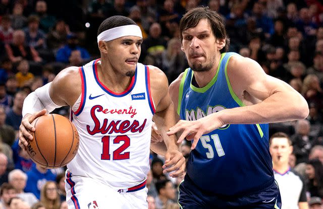 <p>Mitchell Leff/Getty</p> Tobias Harris #12 of the Philadelphia 76ers dribbles the ball against Boban Marjanovic #51 of the Dallas Mavericks in the second quarter at the Wells Fargo Center on December 20, 2019 in Philadelphia, Pennsylvania.