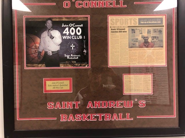 A plaque in the lobby of the St. Andrew's gym commemorates John O'Connell's 400th career victory - when the coach had hair. O'Connell earned his 700th career victory with the Scots in a win over Pine Crest on Jan. 28, 2022.