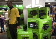 A security guard stands beside a pile of XBOX One video game consoles at a Toys "R" Us store during their Black Friday Sale in New York November 28, 2013. REUTERS/Carlo Allegri