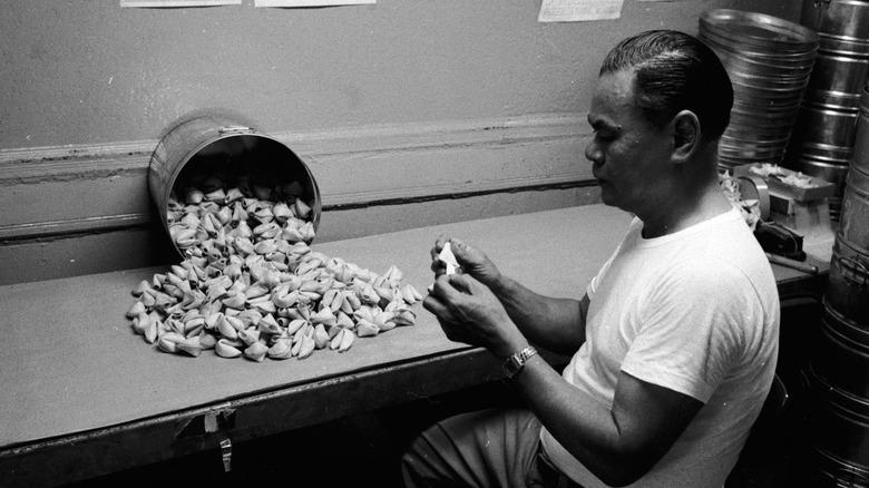 factory owner inspecting fortune cookies