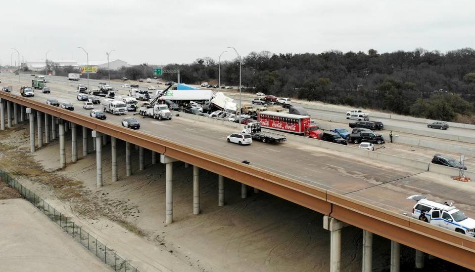 Los socorristas trabajan para retirar los vehículos involucrados en un choque múltiple que causó la muerte de cinco personas en la I-35 cerca del centro de Fort Worth, el jueves 11 de febrero de 2021.