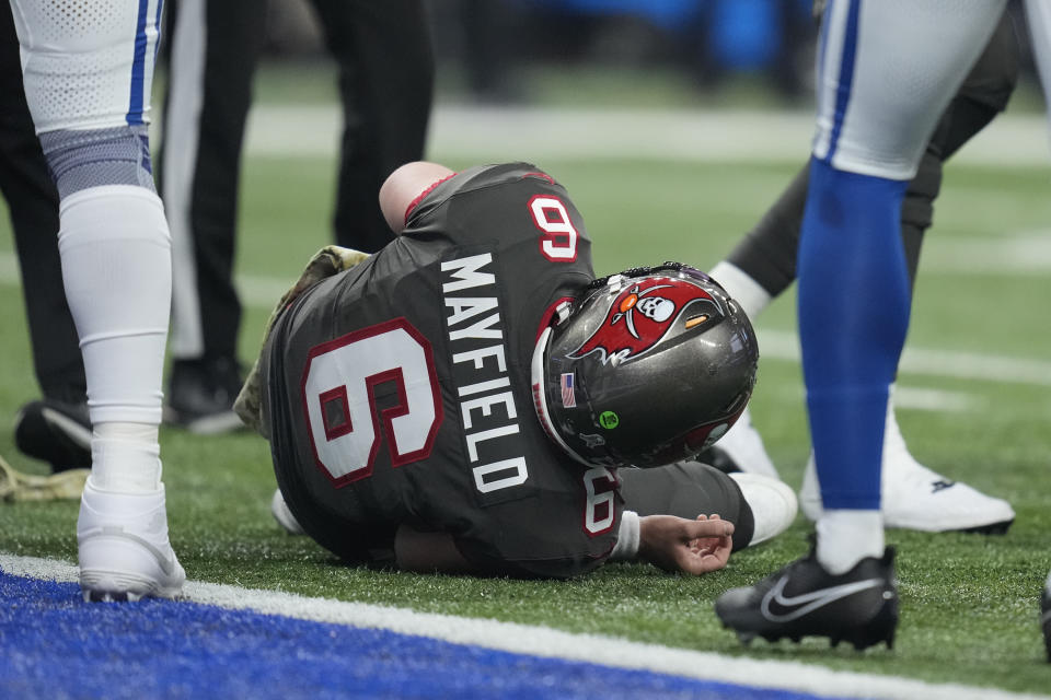 Tampa Bay Buccaneers quarterback Baker Mayfield (6) lays on the ground after being injured during the first half of an NFL football game against the Indianapolis Colts Sunday, Nov. 26, 2023, in Indianapolis. (AP Photo/Michael Conroy)