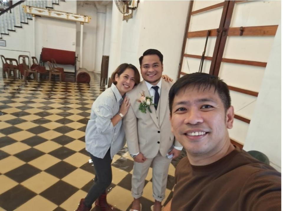 Padilla poses for a photo with his wedding coordinators.